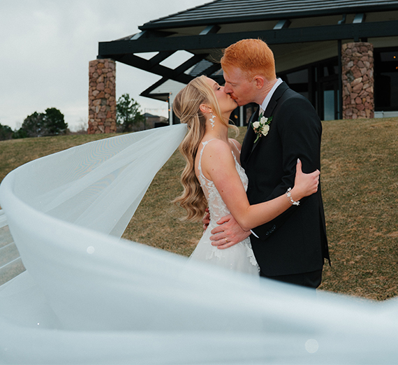 Baby asleep with a tennis ball with a Zag logo on it.